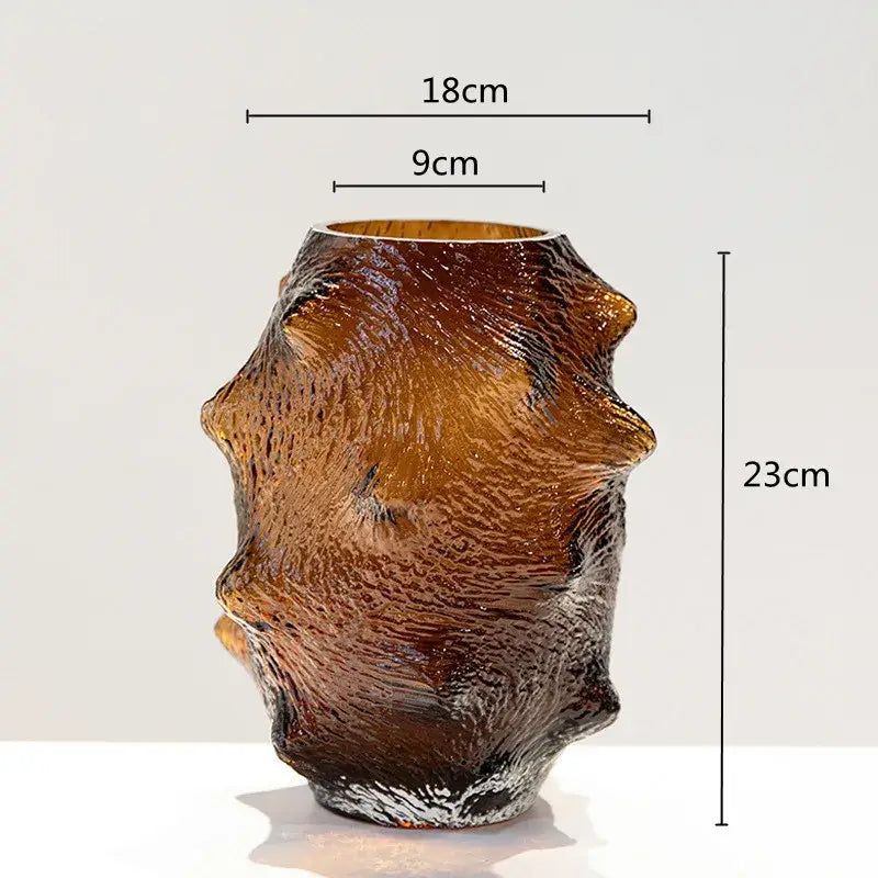 A textured amber sea cucumber glass vase with sculpted organic form and irregular ridges for living room decor