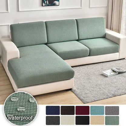 A textured green waterproof elastic sofa cover with a stretchy finish for living room slipcover use
