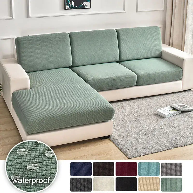 A textured green waterproof elastic sofa cover with a stretchy finish for living room slipcover use
