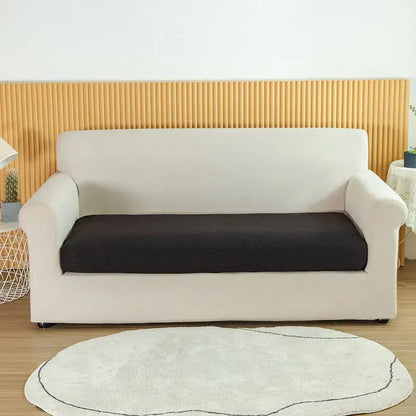 Cream-colored stretch sofa cover with black textured seat cushion for living room slipcover use