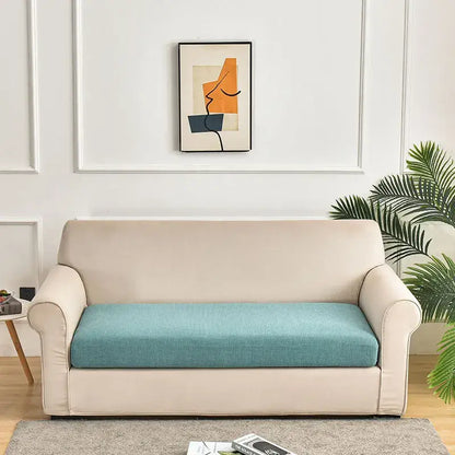 Beige sofa with teal textured cushion and green waterproof elastic sofa cover for living room slipcover use