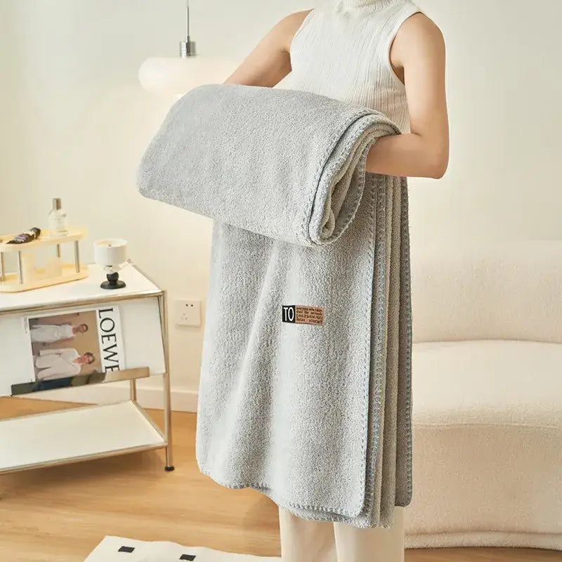 A soft light gray terry cloth bath towel with subtle texture and brown label complements decorbites cloud comforter