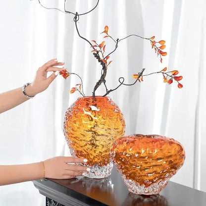 Textured orange and yellow glass colored vase with a reflective metallic base for living room decor
