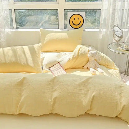 Soft yellow textured decorbites cotton three-layer bedding set with duvet pillows and plush bunny toy on bed