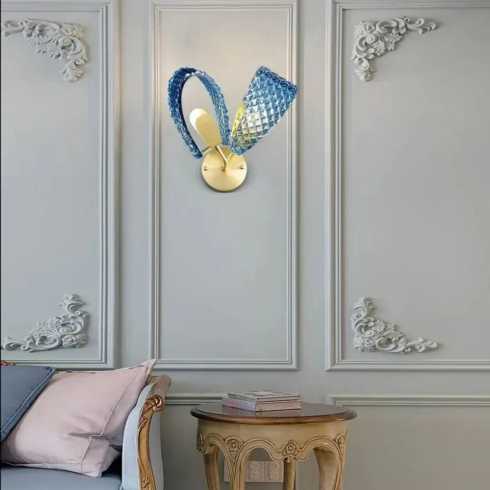 Blue crystal rabbit-shaped wall sconce with gold-toned base for decorbites blue glass luxury bedroom decor