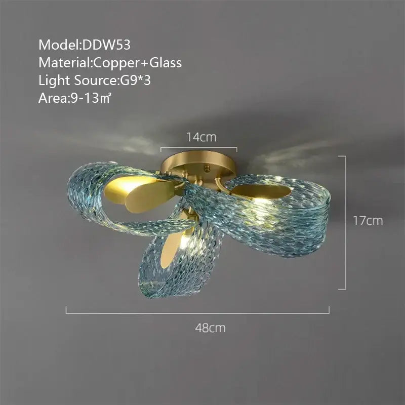 A modern wall sconce with a copper base and flowing textured turquoise decorbites blue glass luxury arms for bedroom decor