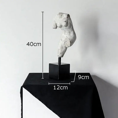 A weathered white body art resin sculpture of a female torso on a black base by decorbites for living room decor