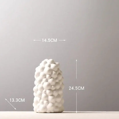 White ceramic vase set with textured bubble-like surface and artificial flowers for living room decor