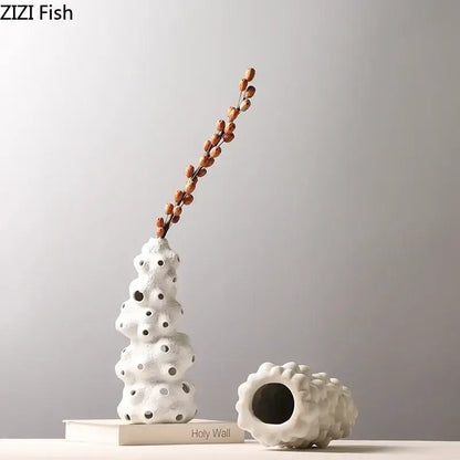 White textured ceramic vase set with porous surface and artificial flowers for living room decor