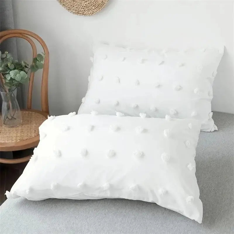 White pillow with soft textured fabric and pom-pom embellishments in decorbites furball double duvet set bedding