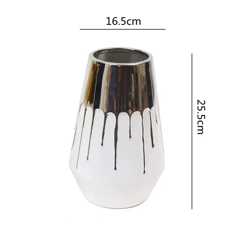 A sleek white and golden ceramic vase with glossy silver rim and black drips for living room decorbites golden ceramic decor