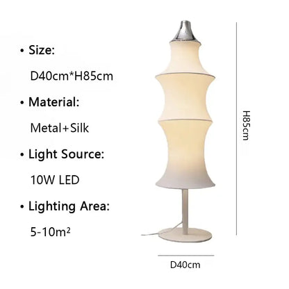 A tall floor lamp with a cream silk tiered japanese shade and metallic base for soft living room lighting decorbites cream silk