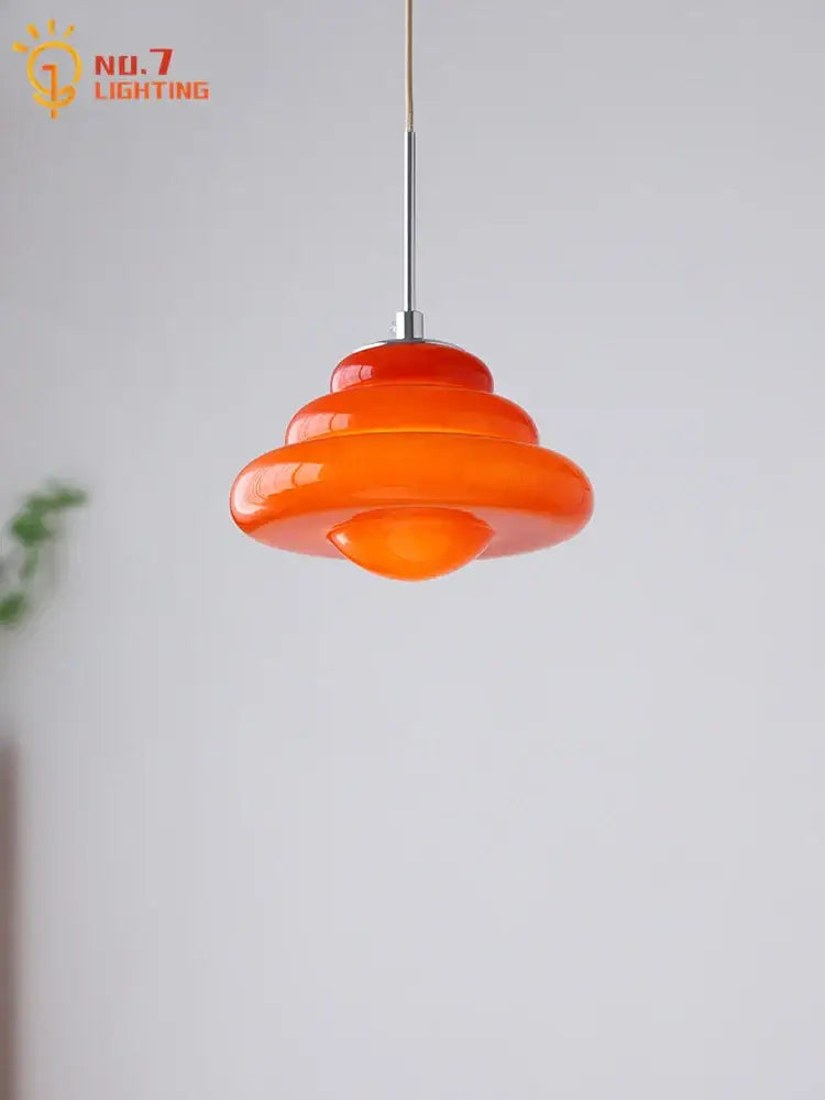 Vibrant orange layered decorbites cream glass pendant lights with a sleek chrome stem for kitchen use