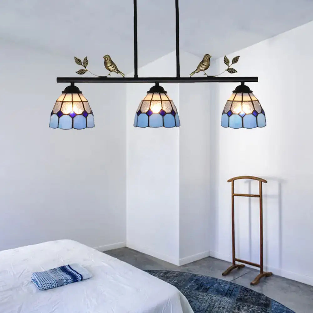 Three-light tiffany-style pendant light fixture with blue stained glass shades and a black metal curved bird shape frame