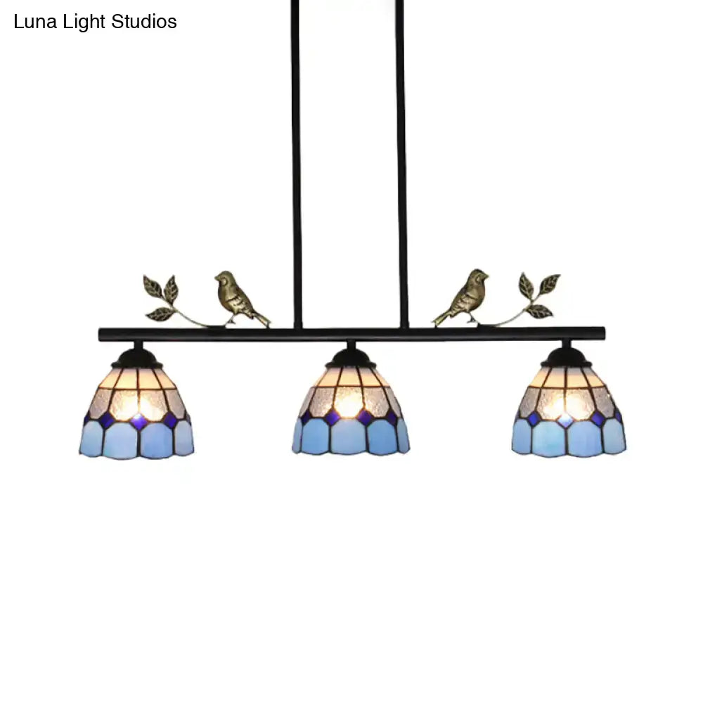 Blue stained glass pendant light fixture with brass curved bird shape and leaf accents by DecorBites™