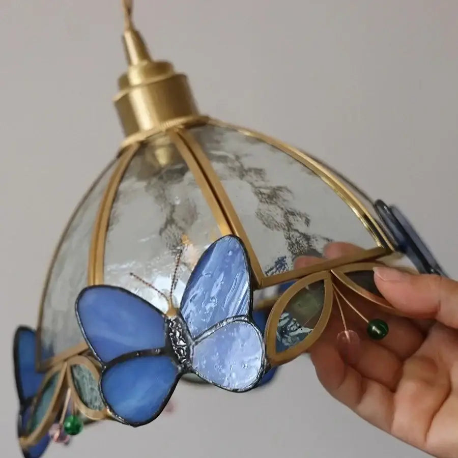 Blue stained glass butterfly pendant wall lamp with gold-toned brass frame and clear textured panels for decorbites tiffany butterfly glass