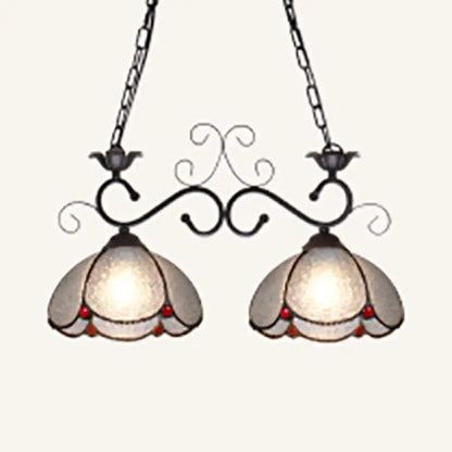 Vintage-style scalloped edged island light with black wrought iron arms frosted glass shades and red bead accents