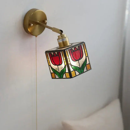 A brass-finished wall light with colorful square glass featuring red tulips for decorbites colorful square bedroom sconce