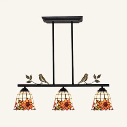 Black antique brass chandelier with three stained glass sunflower shades and bird accents in tiffany style design