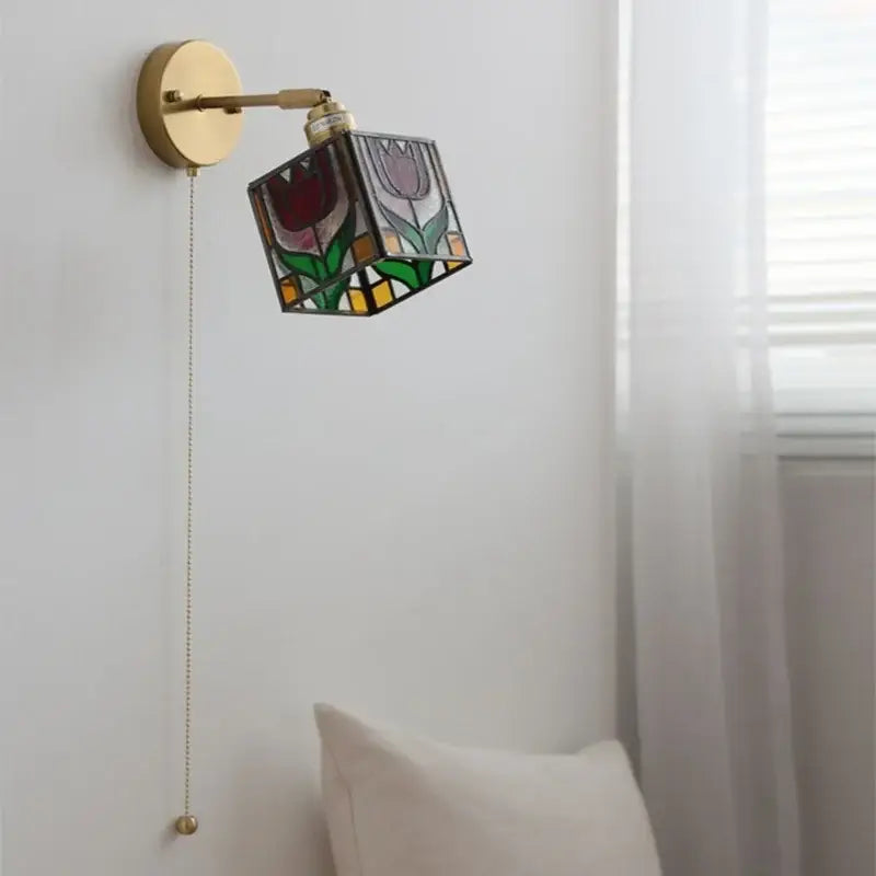 A brass wall sconce with colorful square glass featuring red purple green and yellow floral design for bedroom decorbites wall lights