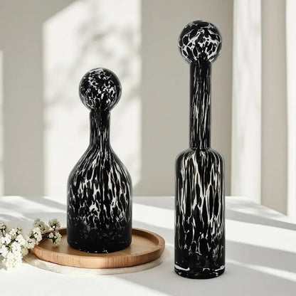 Two black and white marbled glass decanters with spherical tops for decorbites leopard print glass living room decor