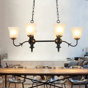 Traditional black and gold pendant ceiling lamp with white glass shades and wrought iron in dining room setting