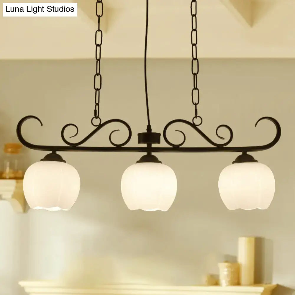 Black wrought iron DecorBites traditional island lighting fixture with three frosted glass globe shades for dining room