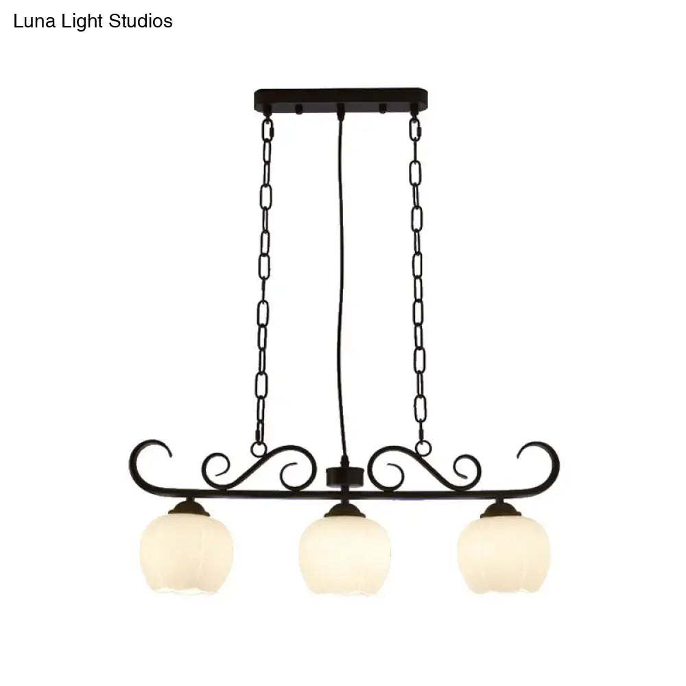 Black wrought iron DecorBites™ traditional island lighting fixture with three milky glass globe shades for dining room