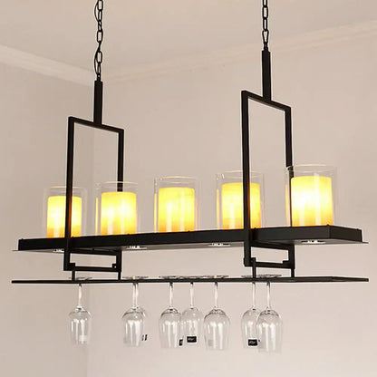 Black metal chandelier with five glowing candle lights and metal wine glass rack in traditional black marble finish