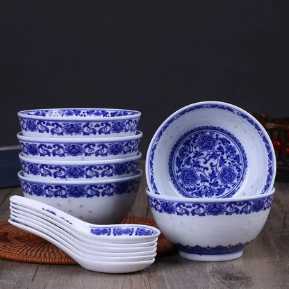 Set of six white porcelain dragon rice bowls with intricate blue floral patterns and matching spoons for dining use