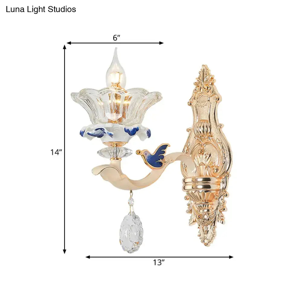 Traditional brass wall sconce light with gold finish, clear flower glass shade, blue enamel, and crystal teardrop for living room