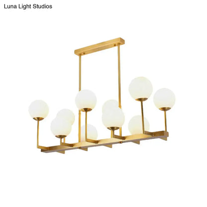 Decorbites opal glass island pendant light in traditional brass with multiple frosted globe shades for dining room