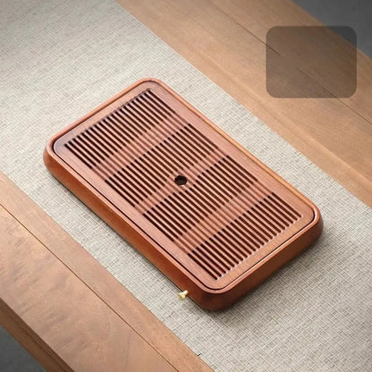 Traditional brown bamboo tea tray with water storage features a rectangular wooden design with drainage grooves and central hole