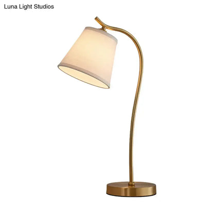 DecorBites™ brass single fabric bedside lamp with a sleek brass finish and traditional bucket table design for 220v-240v use