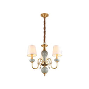 Traditional gold and blue chandelier with metal frame and ceramic orbs as dining room light with shades