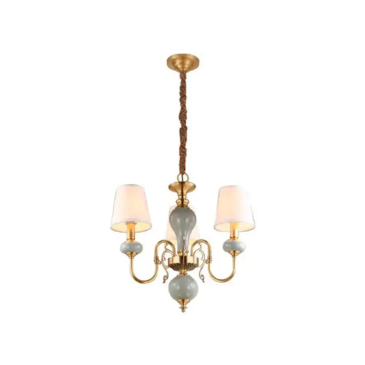 Traditional gold and blue chandelier with metal frame and ceramic orbs as dining room light with shades