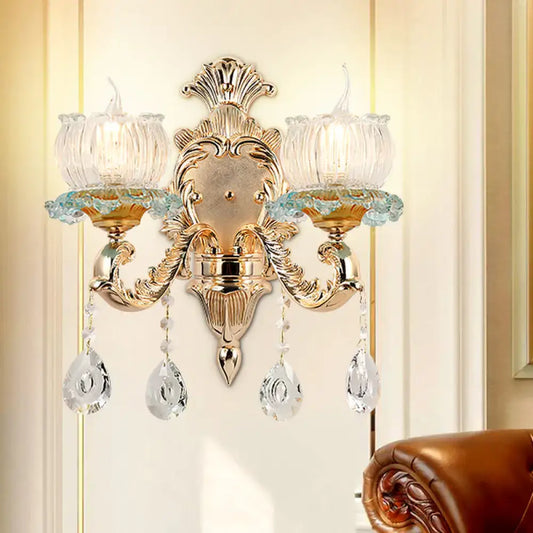 Traditional gold crystal wall sconce with e12 clear glass candle shades and dangling crystal teardrop pendants for restaurant lighting