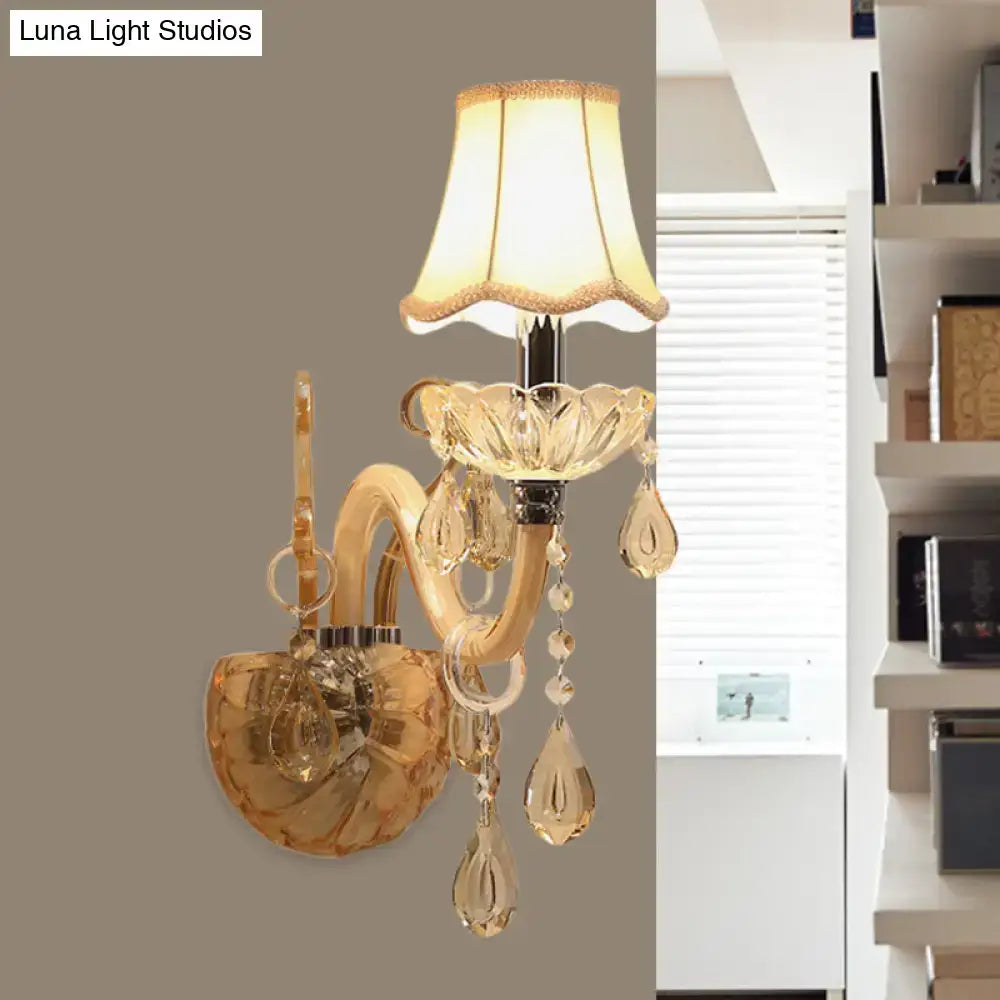 Traditional gold crystal wall sconce with fabric shade featuring a fluted glass shade and dangling teardrop crystals