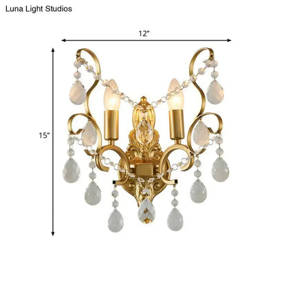 Traditional gold metal candle wall lamp featuring three candle bulbs and dangling crystals for elegant living room decor