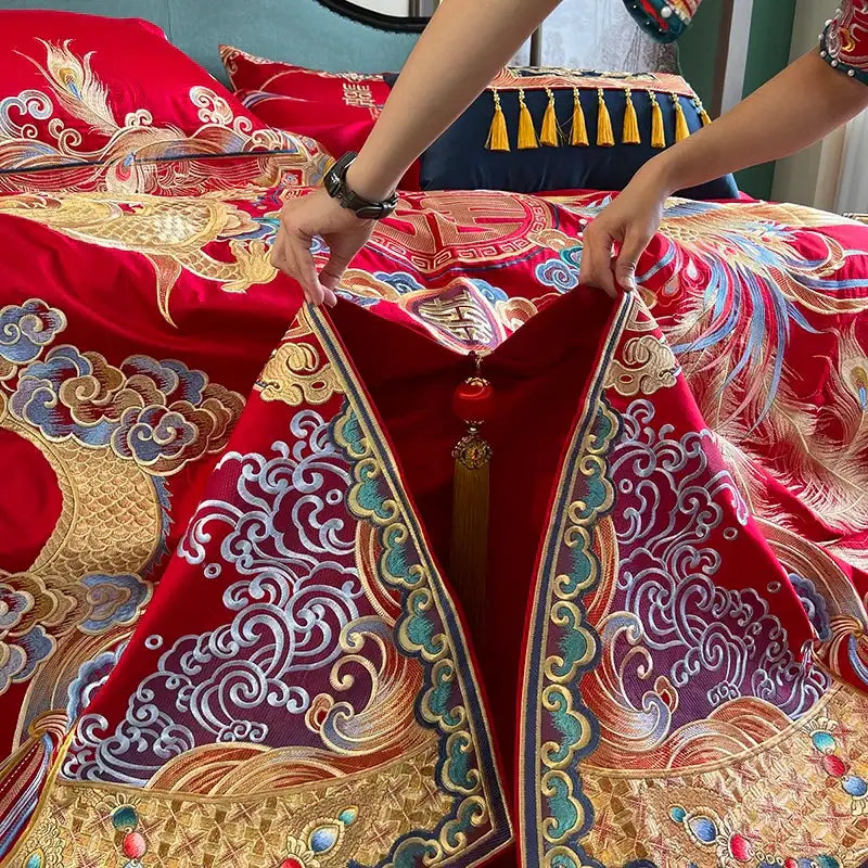 Red satin wedding quilt with intricate gold blue and silver embroidery featuring phoenixes for luxury gold loong bedding set decorbites
