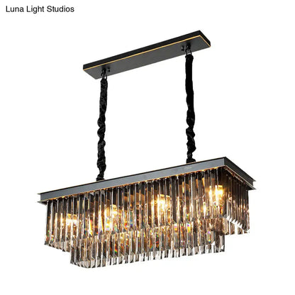 Rectangular light fixture with black metal frame and smoke gray crystal prisms for dining room illumination