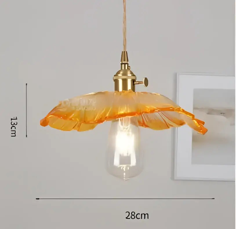Orange glass pendant light with brass fixture and exposed bulb complementing decorbites blue glass pendant lights