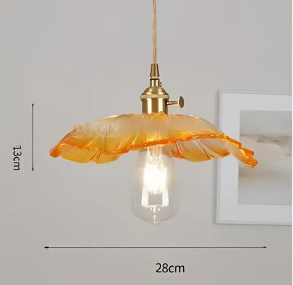 Orange glass pendant light with brass fixture and exposed bulb complementing decorbites blue glass pendant lights