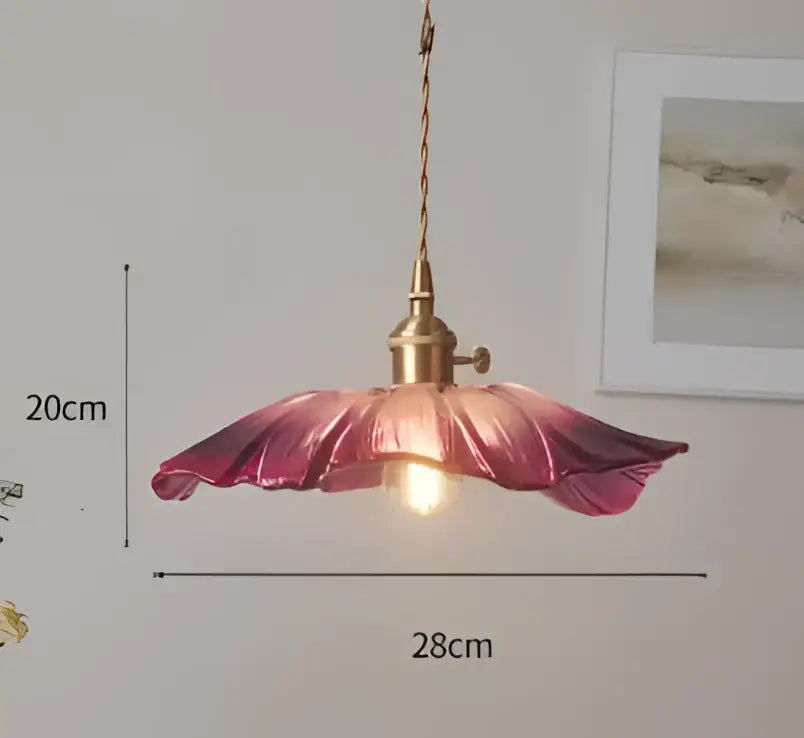 A delicate pink glass pendant light shaped like an open flower with brass fixture and twisted cord for decorbites blue glass pendant lights