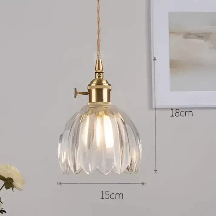 Vintage-style pendant light with brass fixture and clear faceted blue glass pendant resembling a flower by decorbites