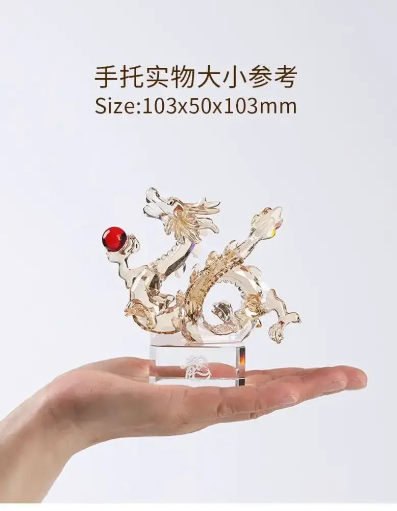 Translucent golden crystal dragon statue with red gemstone on clear base for feng shui decor and decorbites crystal dragon