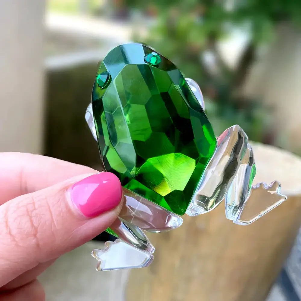 A vibrant green faceted crystal frog figurine with clear glass limbs and eyes for living room decorbites crystal frog decor