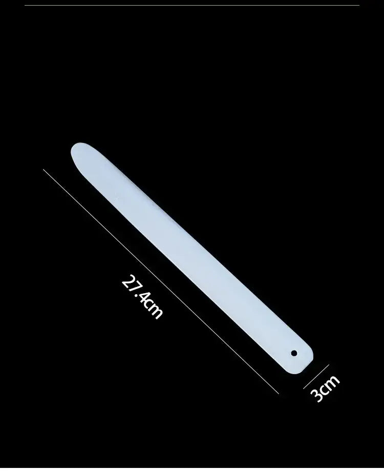 A sleek matte white plastic decorbites coconut opener tool with rounded end and hole for kitchen flesh extraction