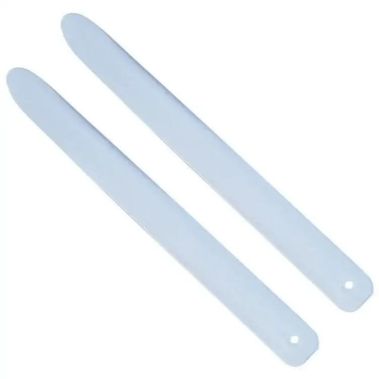 Two translucent white plastic coconut opener tool strips with rounded ends and holes for decorbites coconut opener use