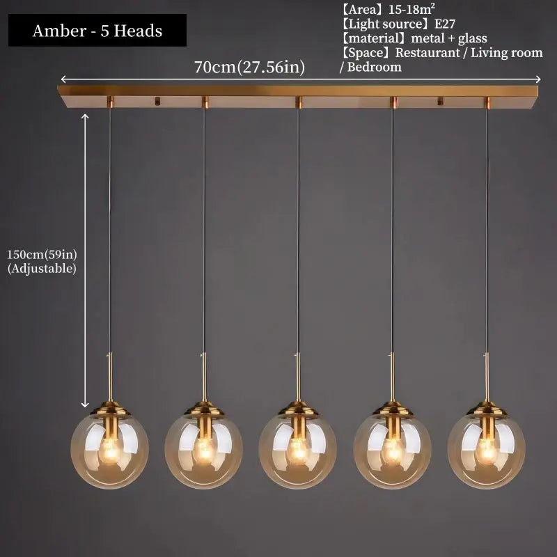 Modern amber glass pendant light with five spherical bulbs and polished steel brass-finished metal fixtures for dining room
